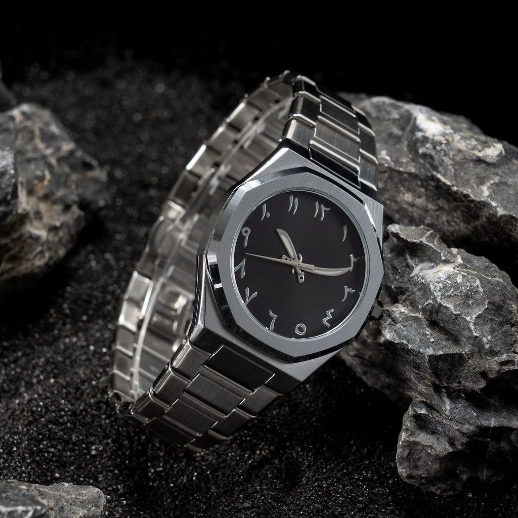 Business casual men's quartz watch with a steel belt on a wrist, showing dial colour options of black, black with silver scale, or silver with black accents.