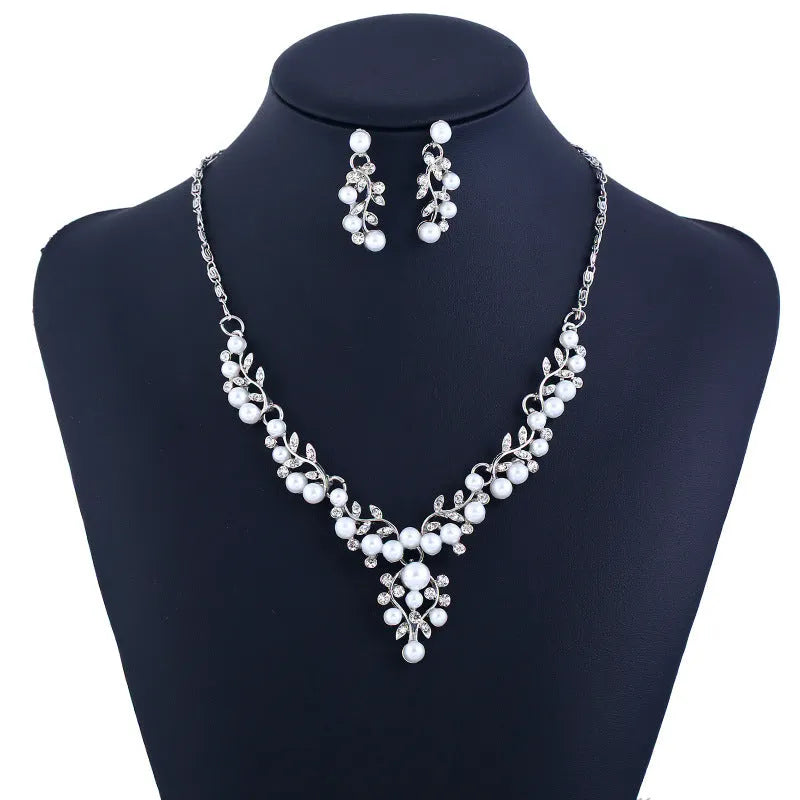 Pearl diamond earring and necklace bride set in gold finish on white background
