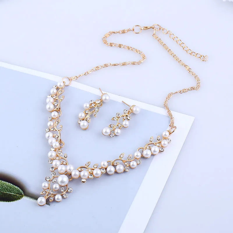 Pearl diamond earring and necklace bride set in gold finish on white background