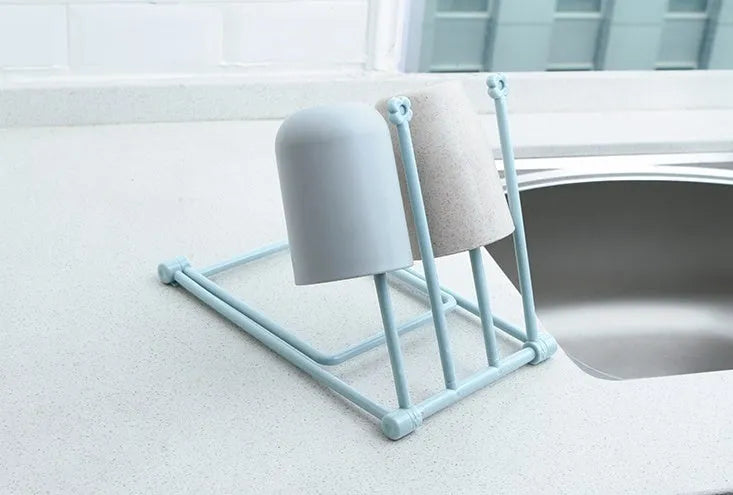Foldable light grey plastic dishcloth shelf with vertical design mounted on a wall