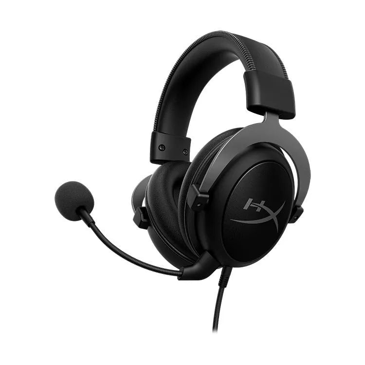 Black and red wired gaming headset with detachable microphone and separate USB sound card remote control on a desk.