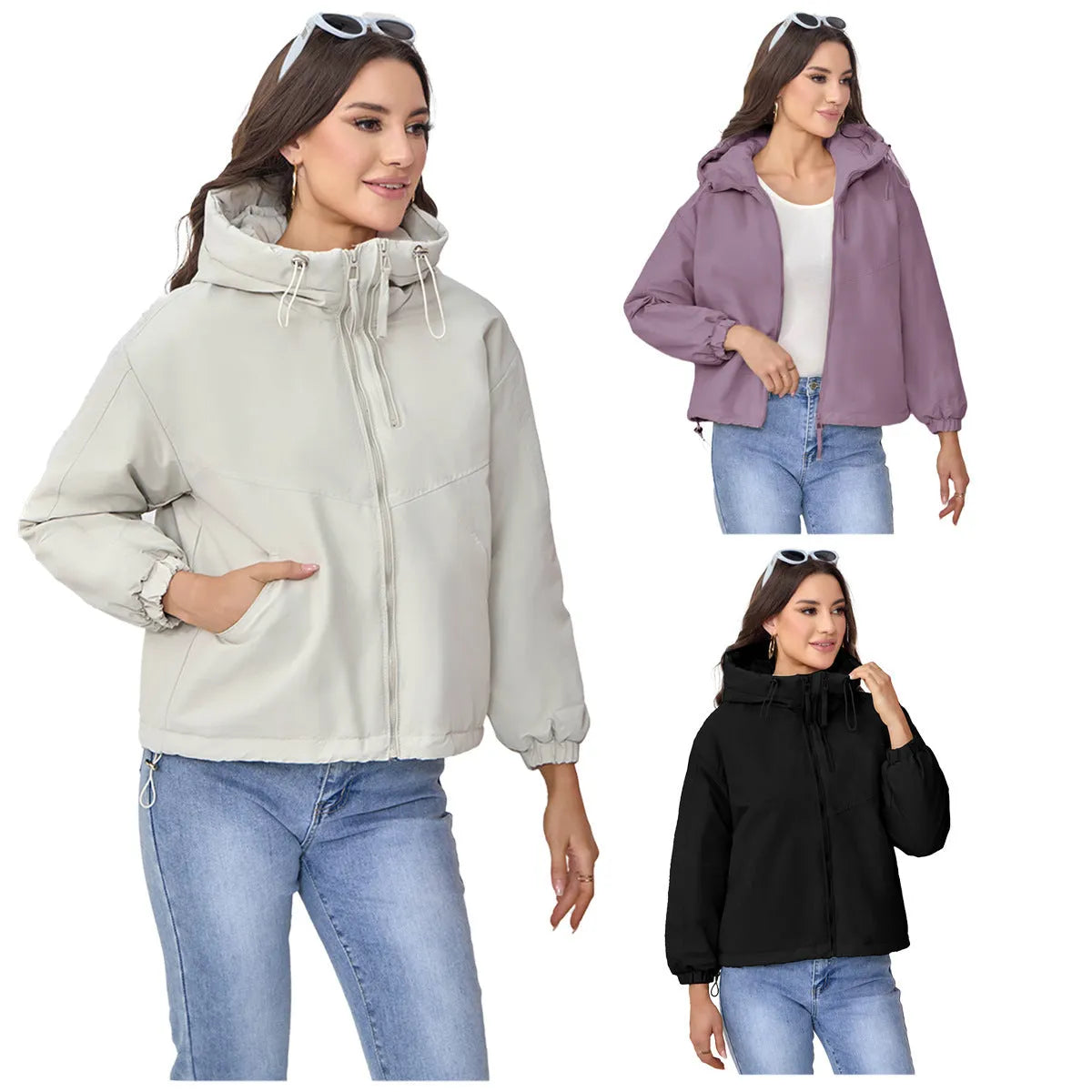 Grey loose-fit women's hooded shell jacket with long sleeves on a hanger.