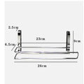 Silver stainless steel kitchen towel rack mounted on a cabinet door holding a paper towel roll.