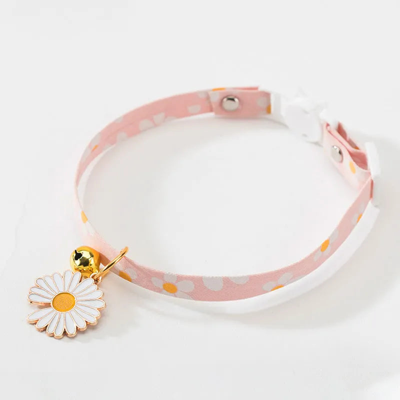 Adjustable green cat collar with a metal bell pendant and a matching bow tie decoration.
