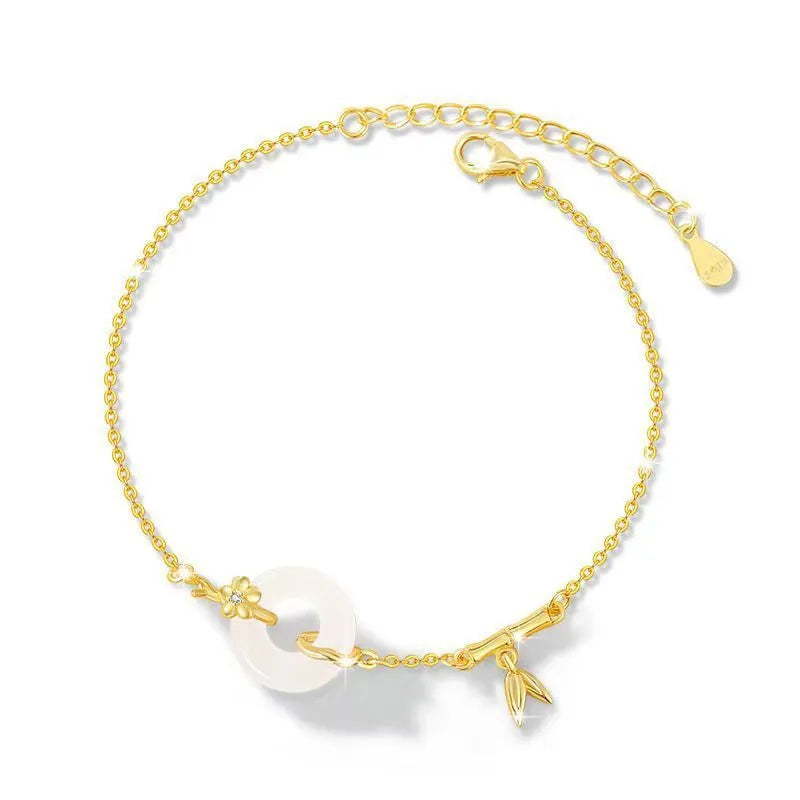 Silver gold electroplated women's bracelet with a white chalcedony stone and prominent peace buckle clasp on a 22 cm band.