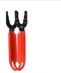 Orange Stanley FatMax pipe wrench with forged steel head and black composite handle on a workbench.