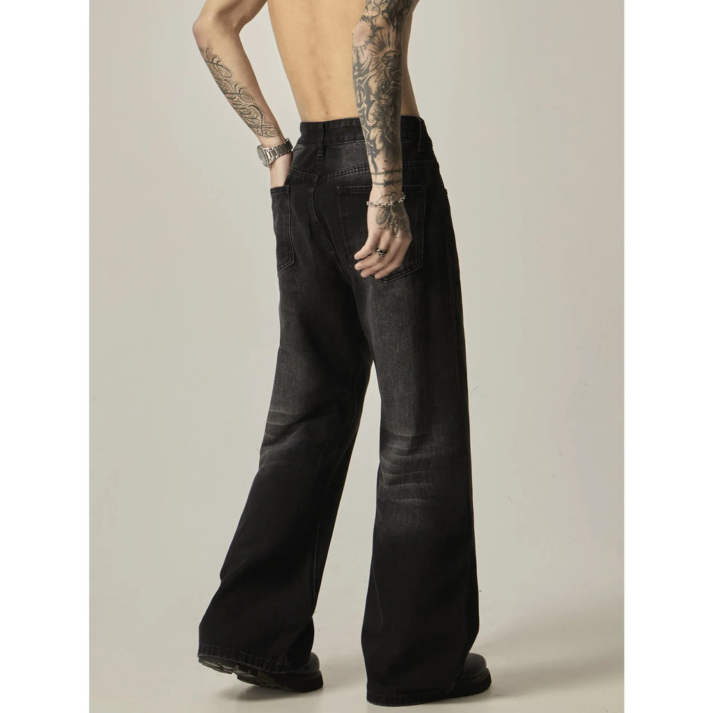 Black loose-fit straight leg denim jeans with a zipper fly on a neutral background.
