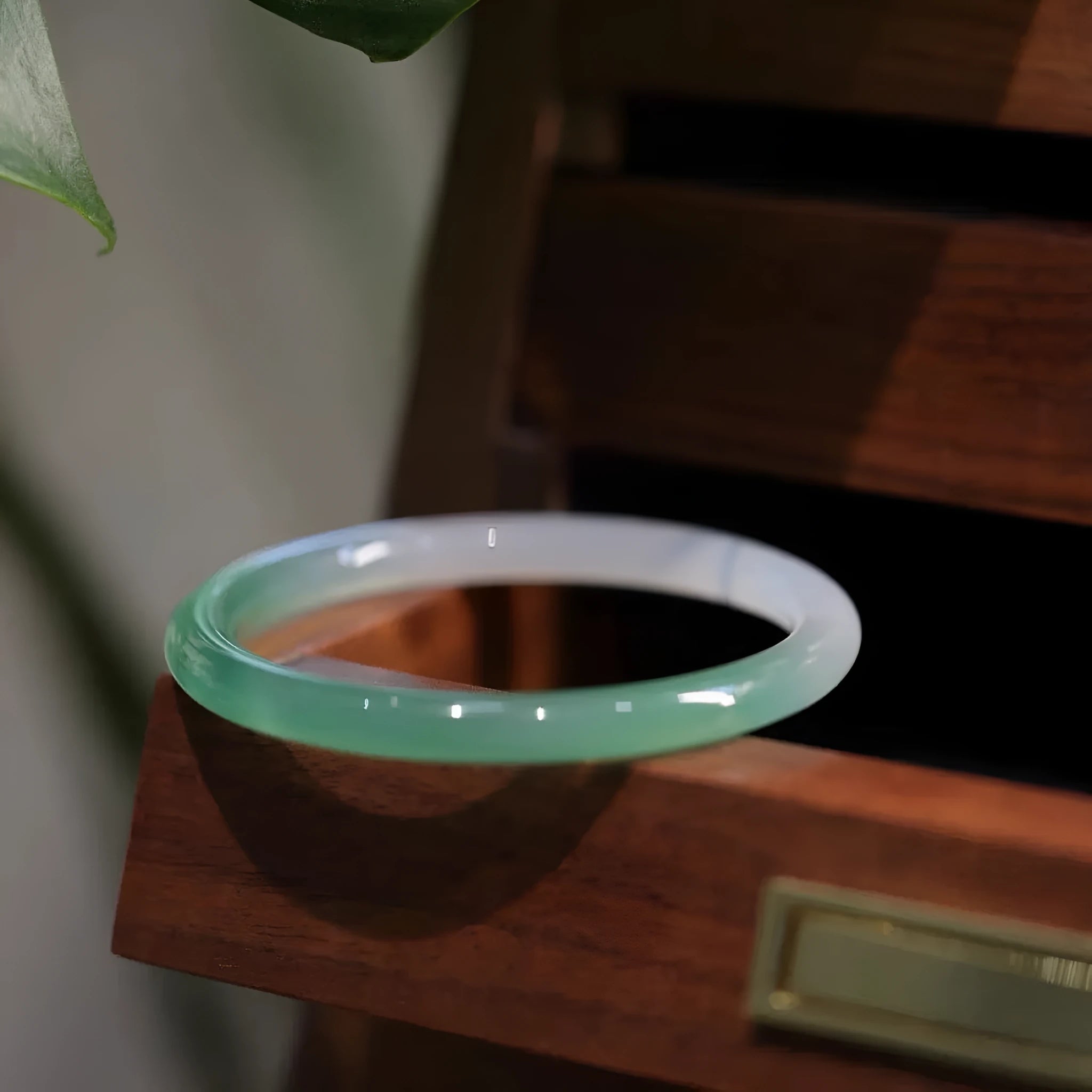 Chalcedony jade bracelet with carved southern mountain and water landscape motif.