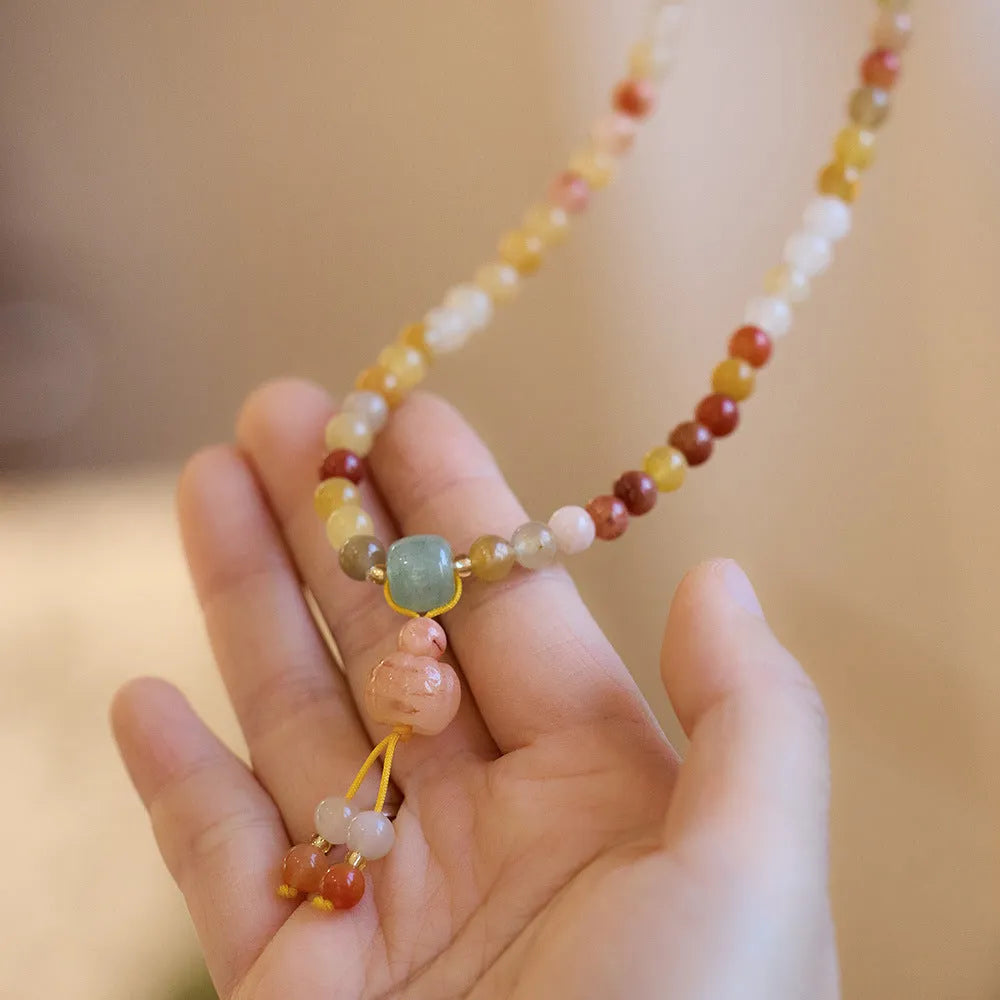 Women's handcrafted Jinsi Jade bracelet with three pumpkin circles and tassel decoration