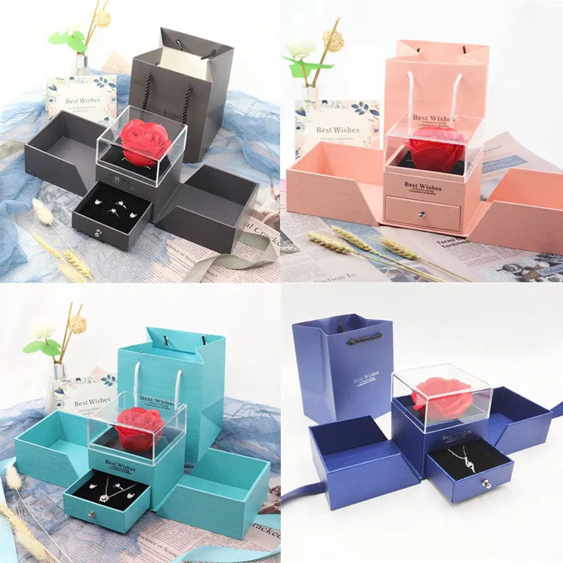 Blue jewellery gift box open to show a plastic eternal rose inside, with space for accessories.