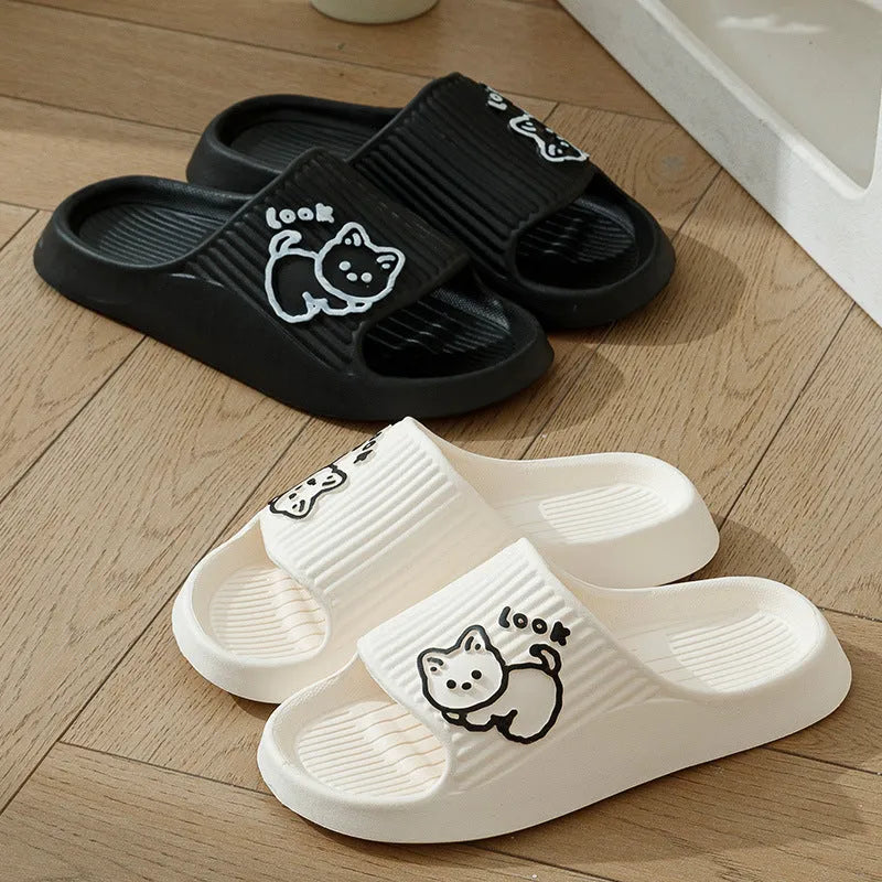 Women's green cat-themed platform slippers with non-slip EVA sole on a wooden floor.