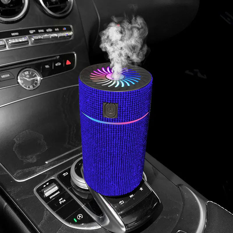 Compact white car air purifier humidifier with USB cord on car dashboard