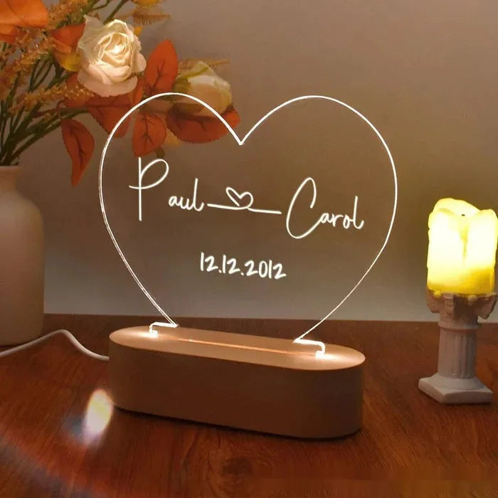 Custom transparent acrylic LED night light personalised with names and date, 20cm by 11.5cm.