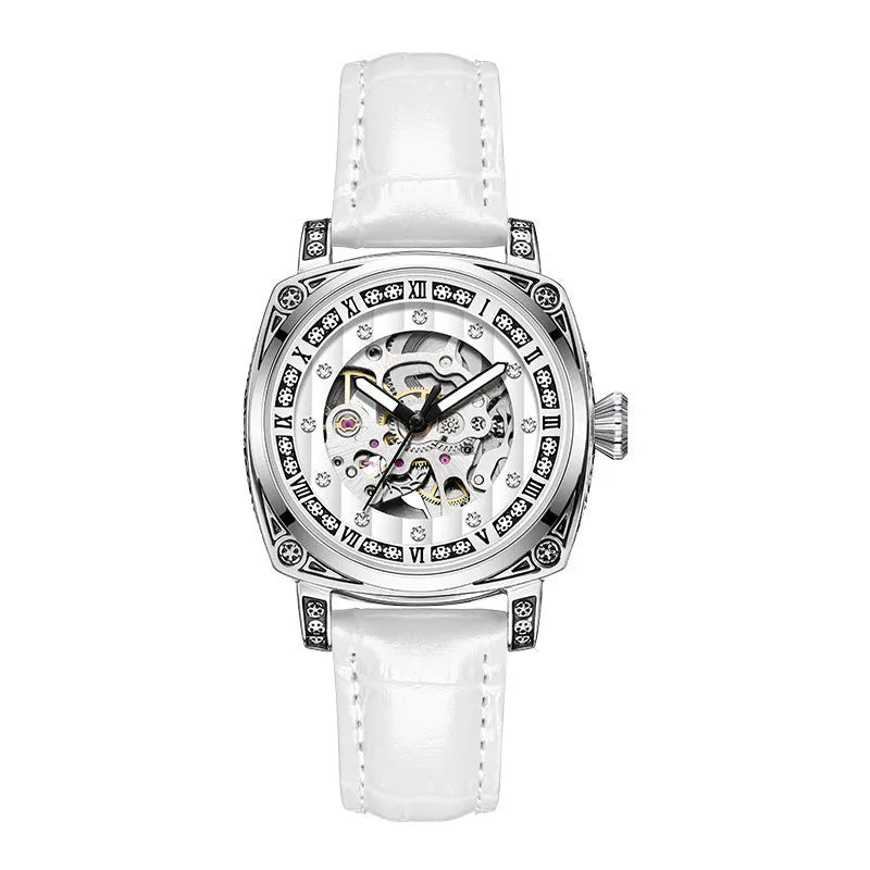 Mechanical watch with luminous hands and a black leather strap on a wrist.