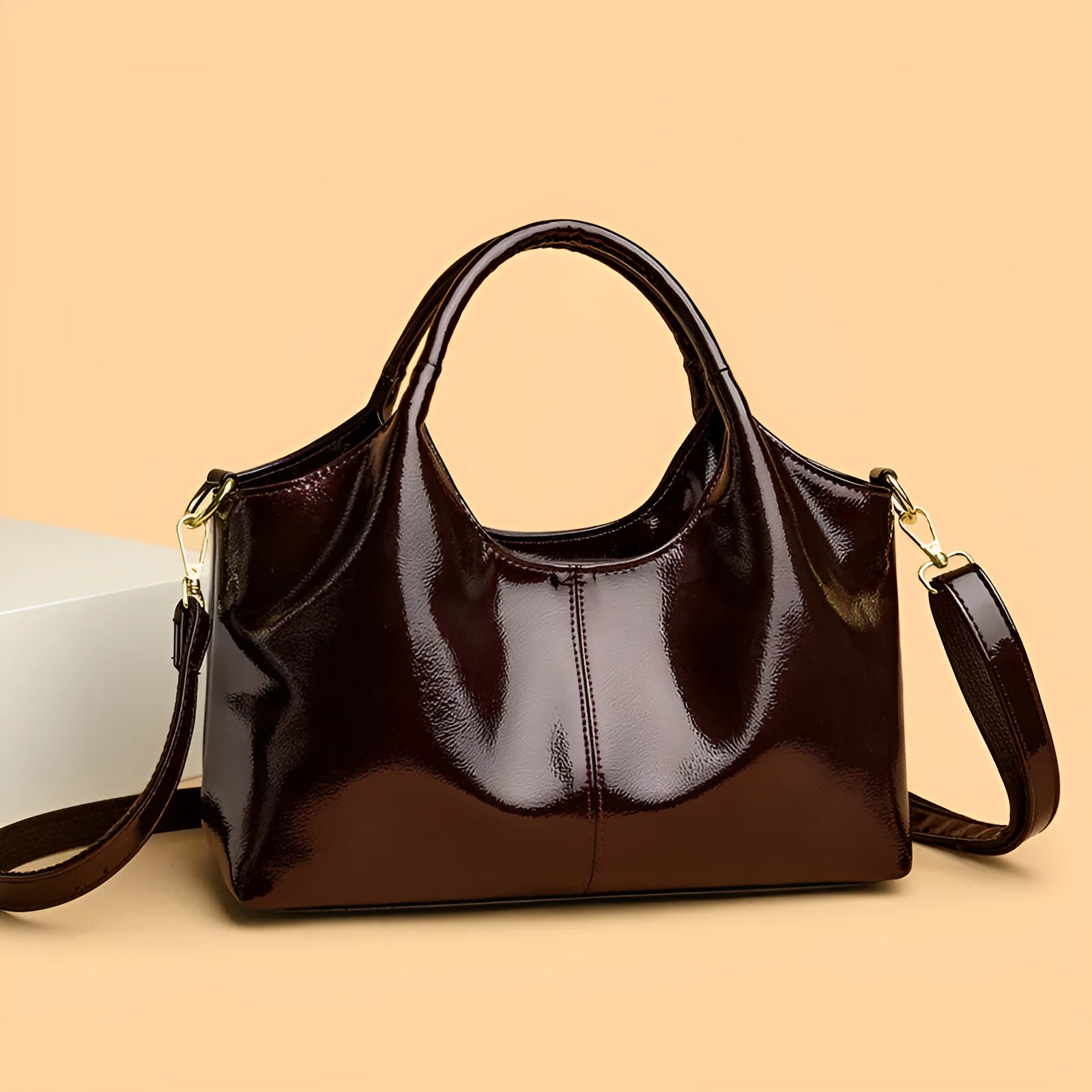 Genuine leather commuter bag with glossy finish, belt decoration, and leather grain in a horizontal square shape