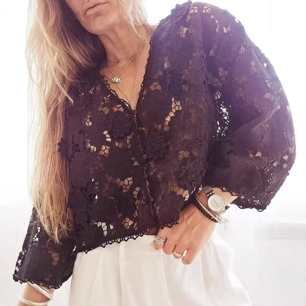 Loose-fit black lace cardigan with 3D flower detailing on a model, showing V-neck and long sleeves.