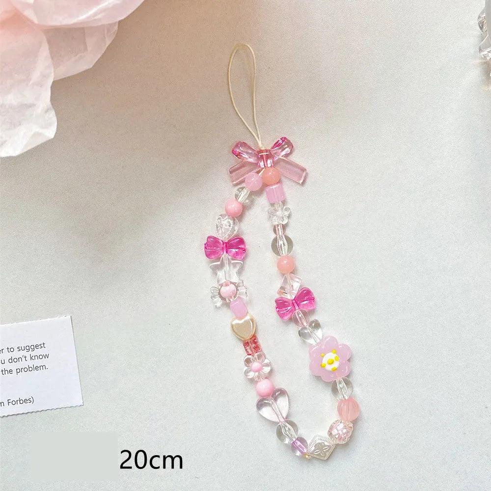 Colourful beaded flower lanyard for mobile phones with blue, pink, or yellow plastic flowers on an adjustable rope strap.