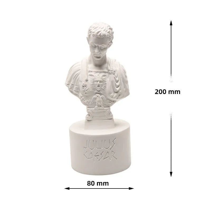 White resin sculpted character pen holder on a desk, holding pens and pencils.