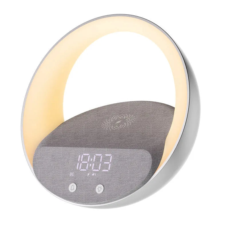 Beige multifunctional wireless charging Bluetooth speaker with clock and adjustable LED mood lighting on a wooden table.
