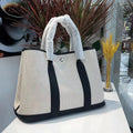 Women's genuine leather canvas tote bag in bucket shape with internal organisation pockets