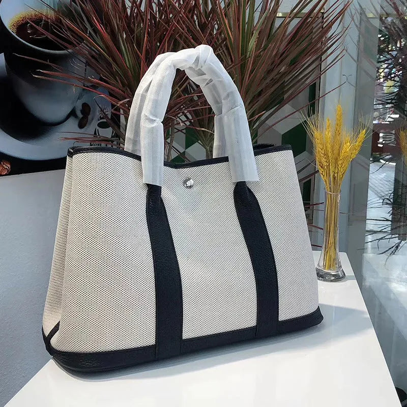 Women's genuine leather canvas tote bag in bucket shape with internal organisation pockets