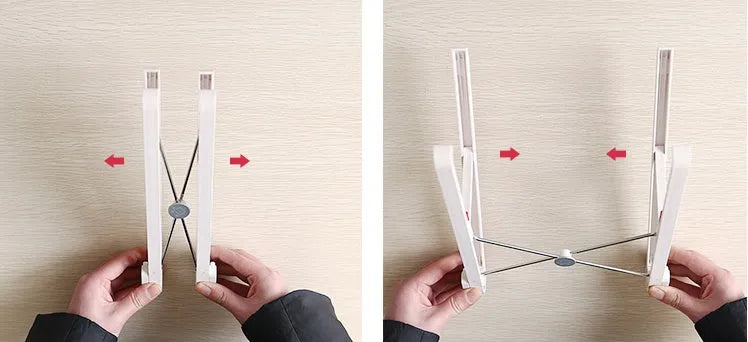 White foldable laptop stand bracket for Apple MacBook on a desktop.