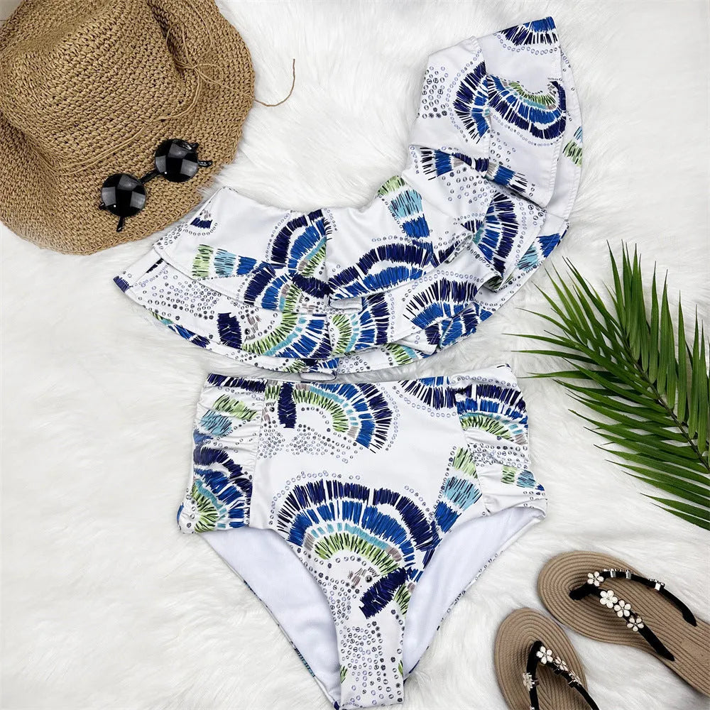 White women's one-shoulder swimsuit with lotus leaf trim and high-leg split.