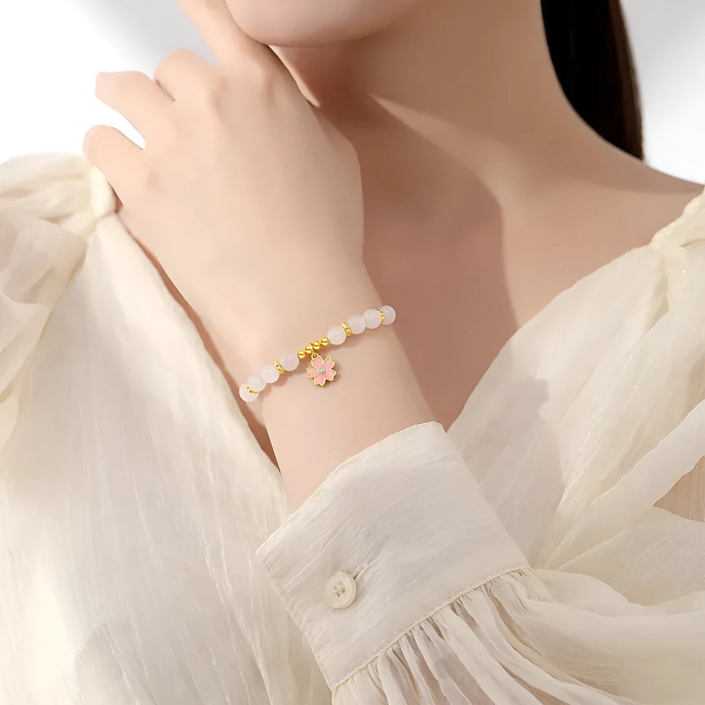 Pink women's bracelet with silver chain, Hetian jade beads, and a detailed cherry blossom flower pendant.