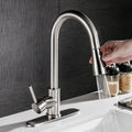 Pull-out hot and cold kitchen faucet with brushed copper finish and single lever lift on a kitchen sink