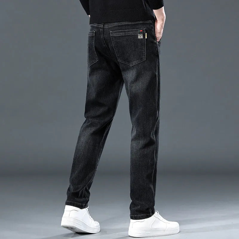 Man wearing slim straight blue grey casual trousers with a zipper fly and mid waist.