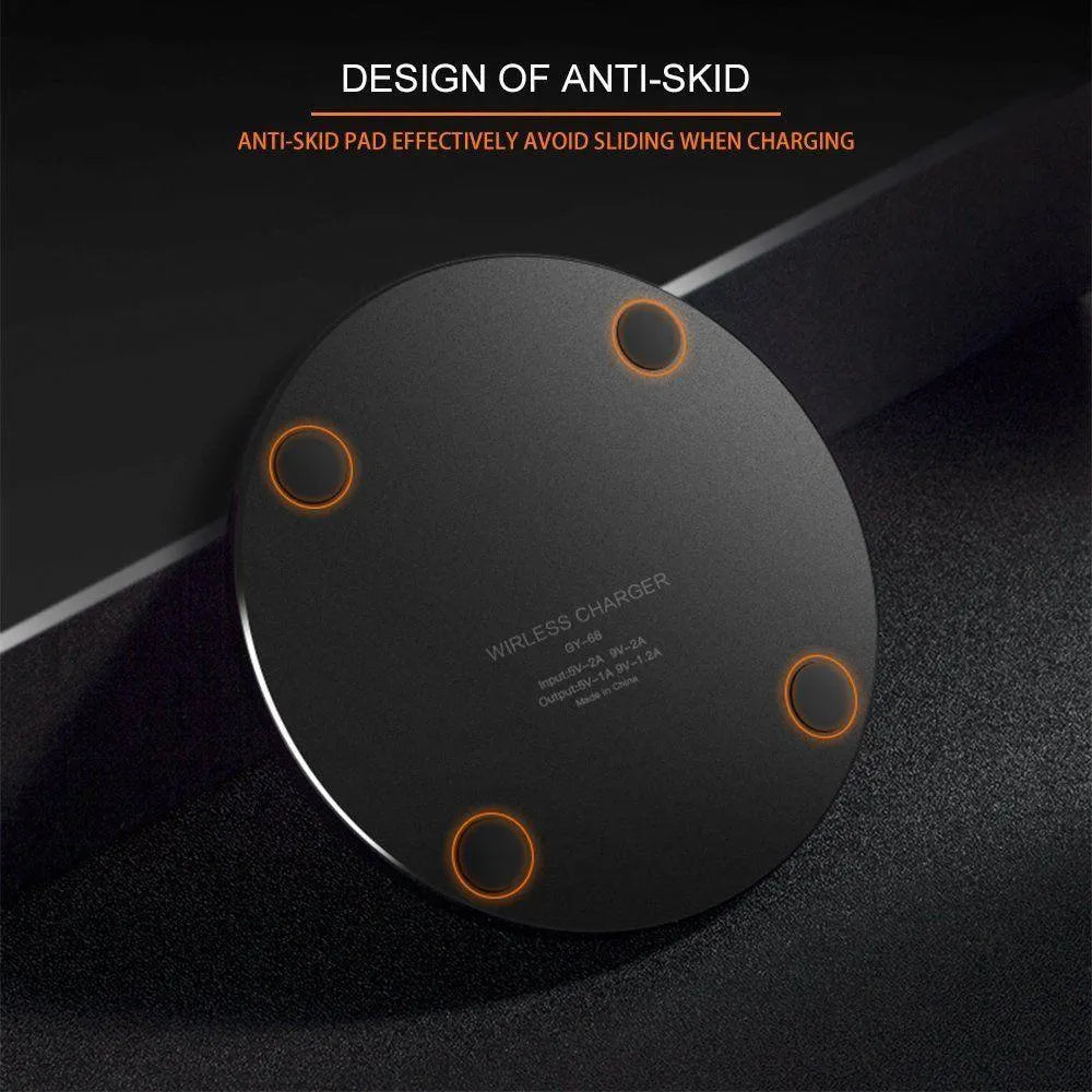 Black ultra-thin square wireless fast charger with USB cable on a desk