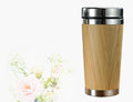 Bamboo coffee cup with double wall insulation, 420ml capacity, and leak-proof lid on table