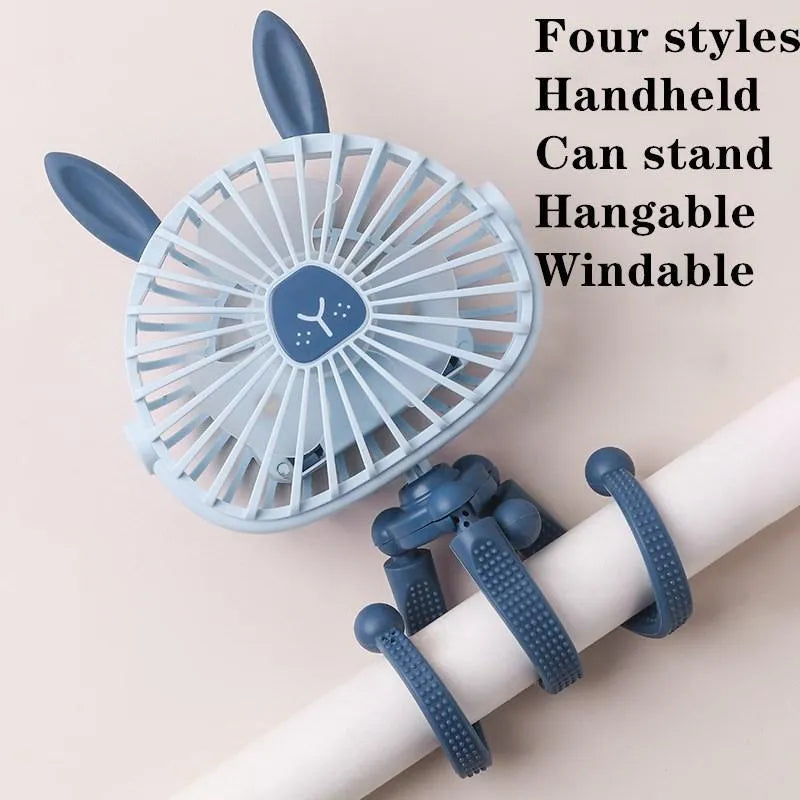 Pink portable USB rechargeable fan with animal design and clip attached to a stroller handle.