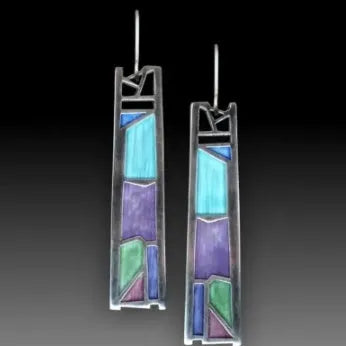 Silver-coloured women's earrings in a water drop shape with an irregular, textured edge design.