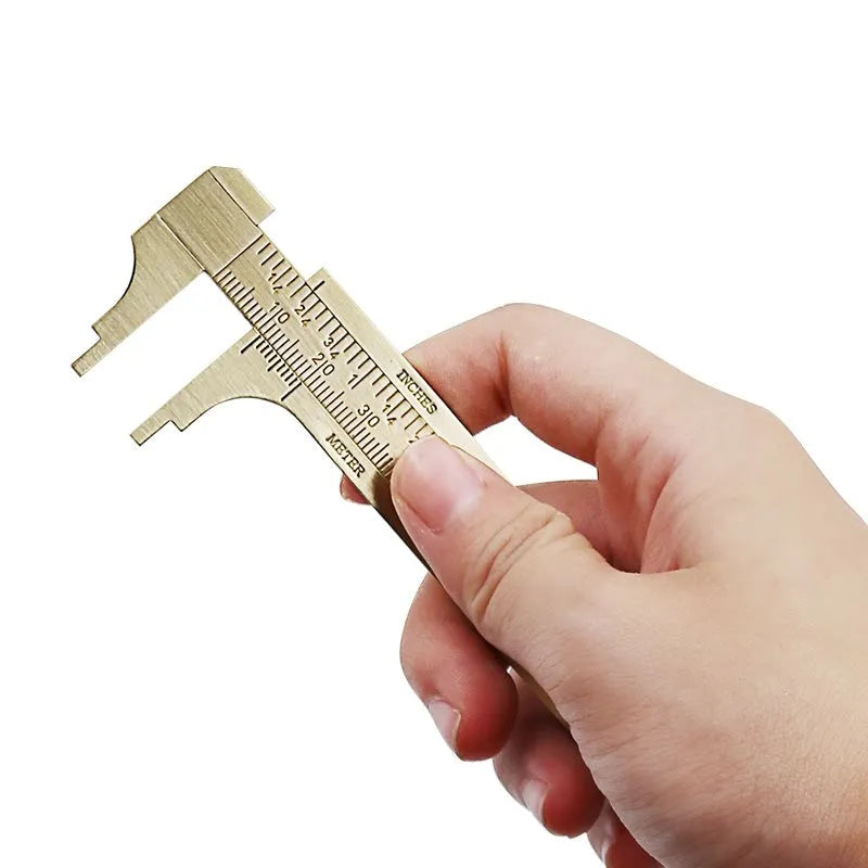 Double scale mini copper caliper 100mm brass vernier with clear markings on wooden surface