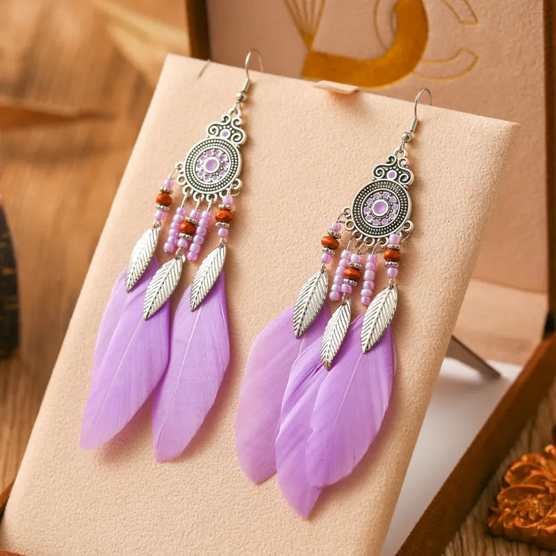 Round drop feather earrings in alloy with electroplated finish showing leaf shape and pattern details