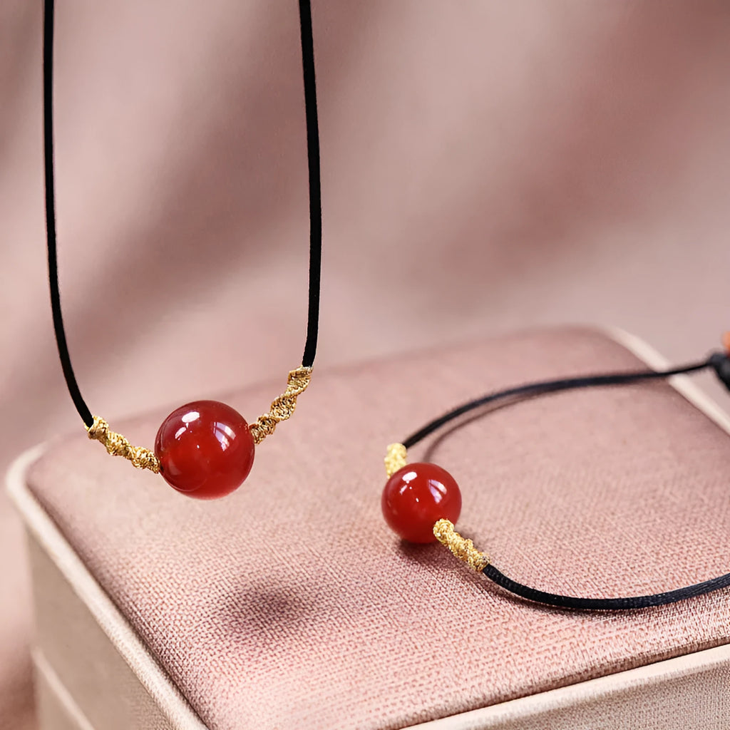 Hand-woven red agate bracelet and necklace set showing bean bead elements