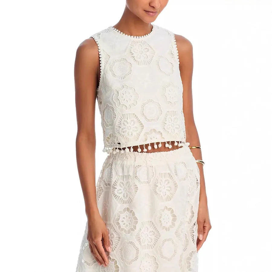 White women's sleeveless top and long skirt set with embroidery detail, laid flat.