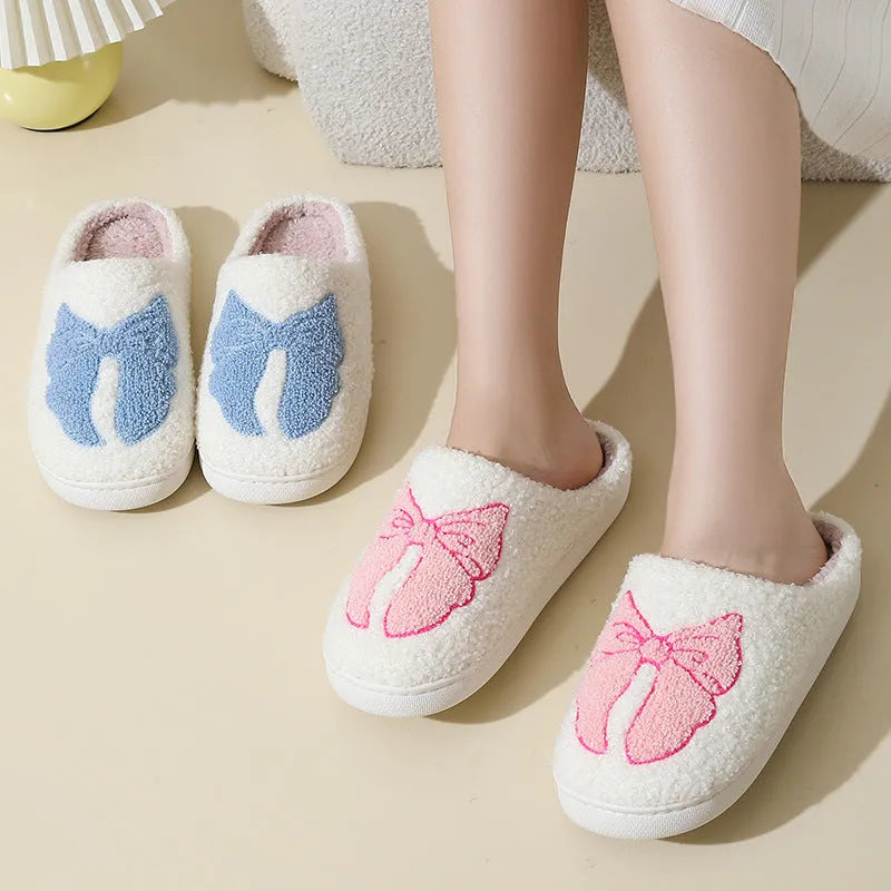Pink and blue cotton suede slippers with a cartoon bow knot design and TPR sole.