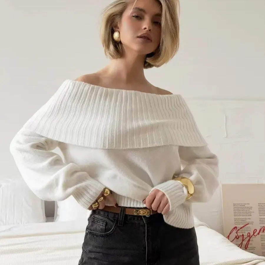 Grey off-the-shoulder women's sweater with a 3D knit pattern and strapless neckline on a hanger.