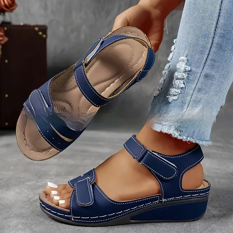 Women's beige strap sandals with thick composite sole and adjustable Velcro fastener on a white background.