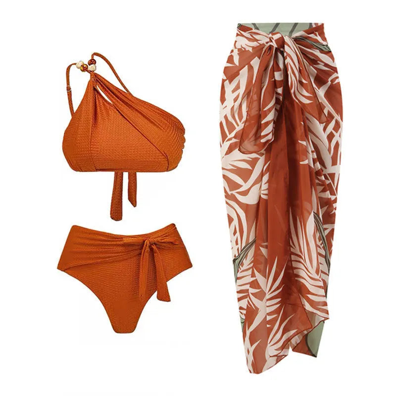 Women's brown high waist bikini with a sheer chiffon dress overlay attached.
