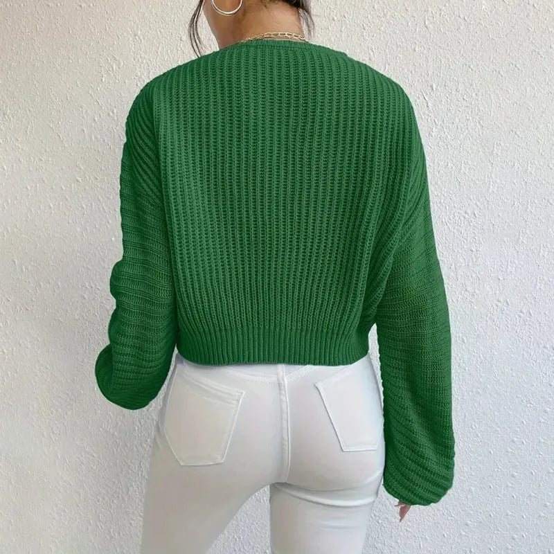 A woman wearing a solid colour long sleeve polyester pullover in a casual, loose fit.
