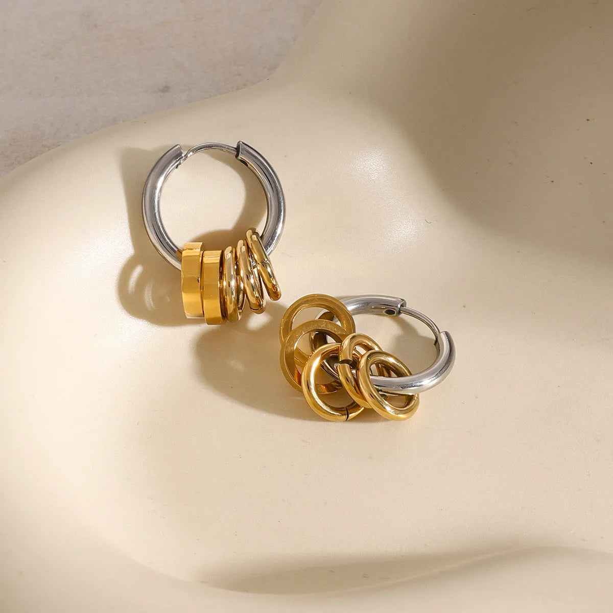 A pair of stainless steel ins style earrings with an electroplated silver or gold tone finish.