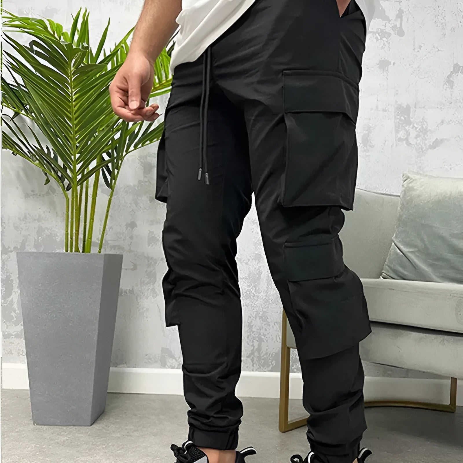Men's stretch breathable nylon ankle banded sports slacks in black, for fitness and leisure