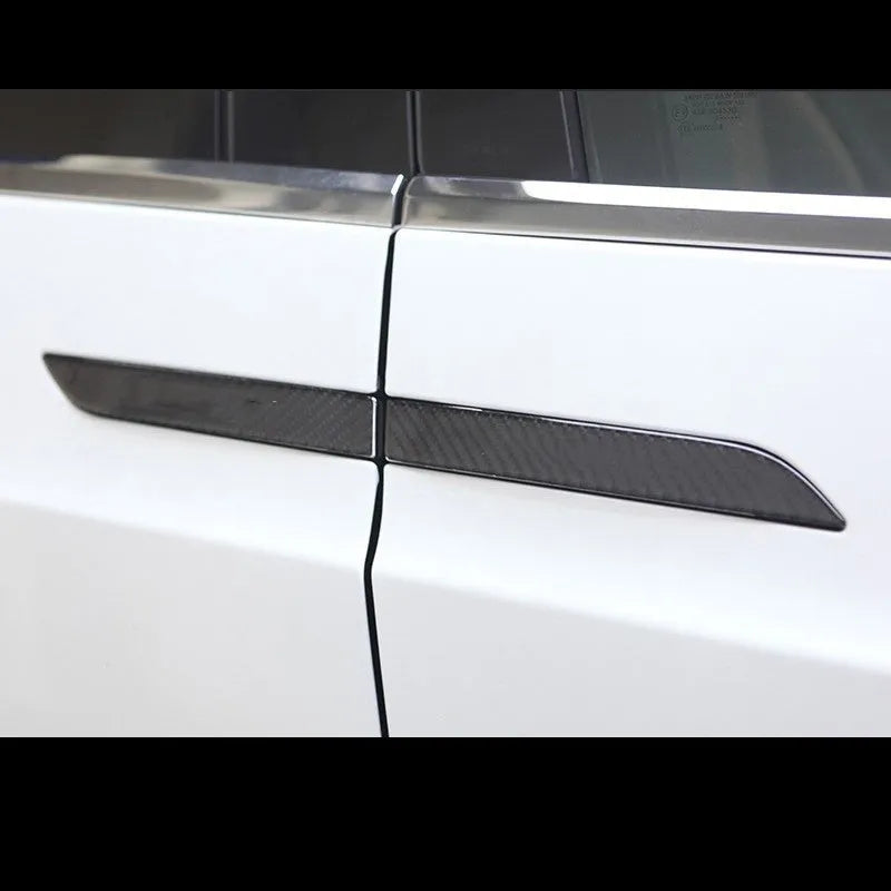 Four black carbon fibre pattern adhesive door handle protectors for a Tesla Model S.