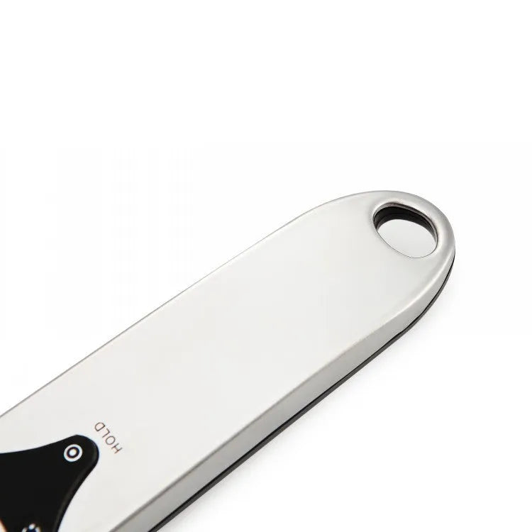 Digital measuring spoon with electronic display showing weight measurement in grams