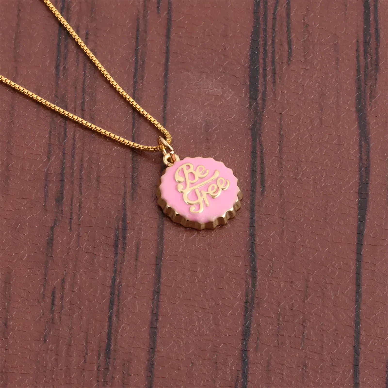 Copper Be Free bottle cap pendant necklace with a 40cm box chain in one of six colour finishes.