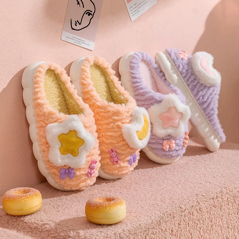 Light blue women's plush slippers with an animal pattern on the round toe holder and a thick fleece lining.