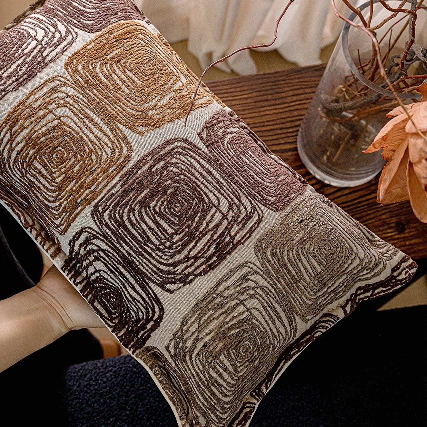 Cream and coffee coloured abstract coil pattern square and rectangular polyester cushion covers.